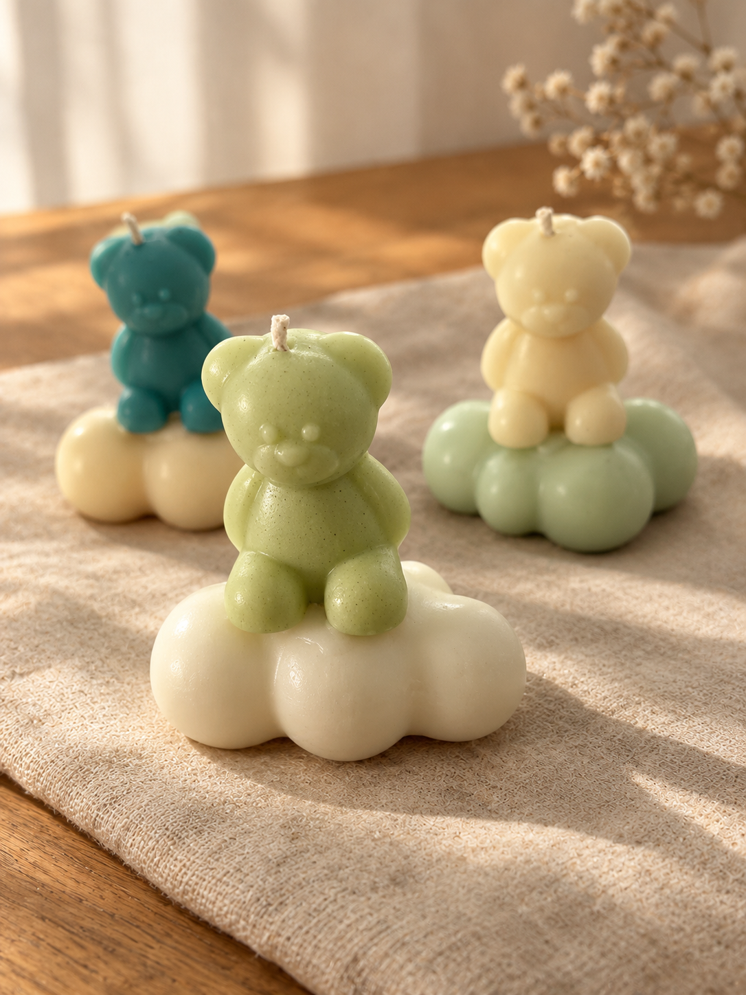 Pastel bear-shaped candles sitting on cloud-shaped bases