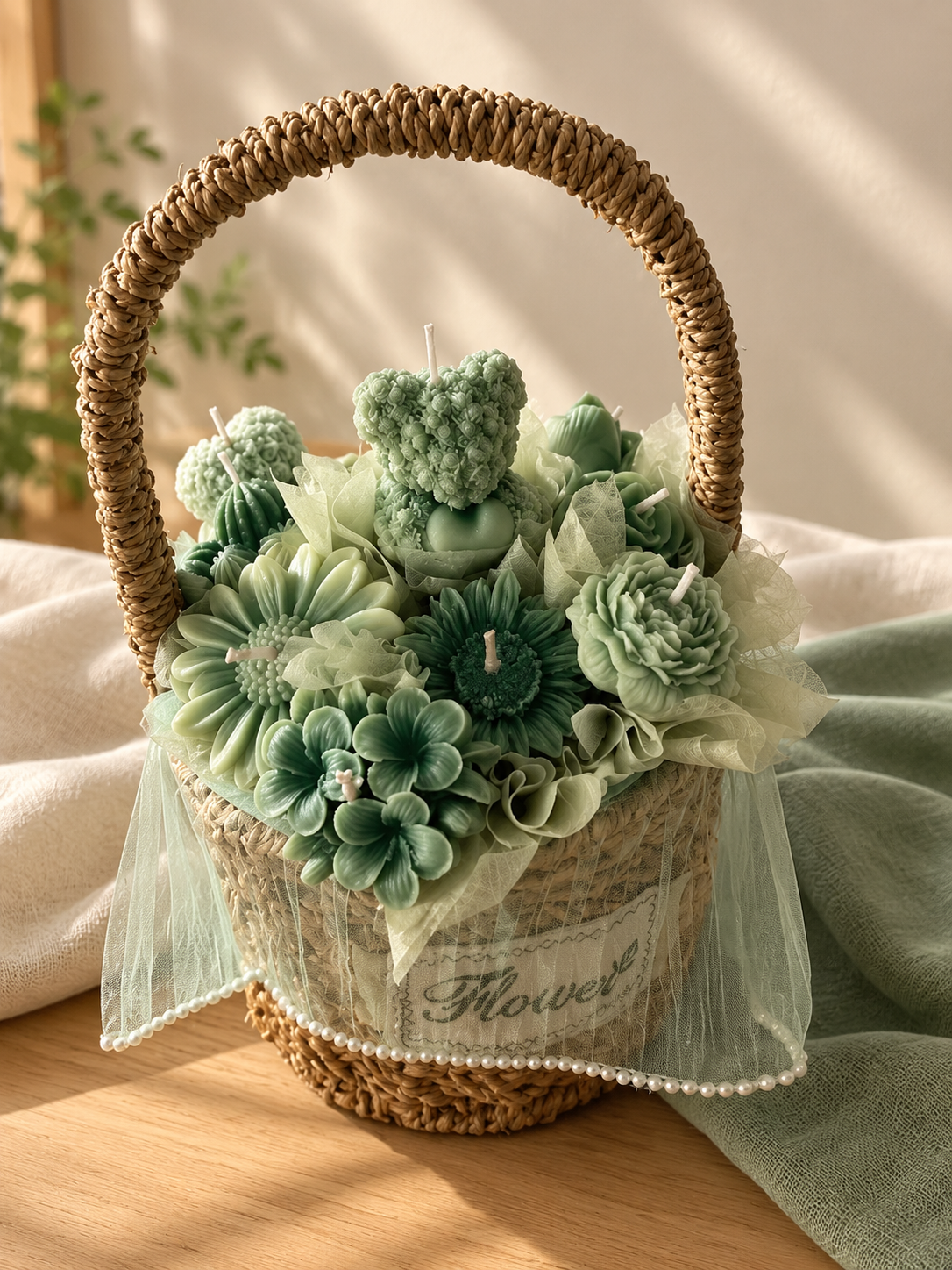 Woven Flower basket of sage green wax flower and bear candles with tulle and pearl trim